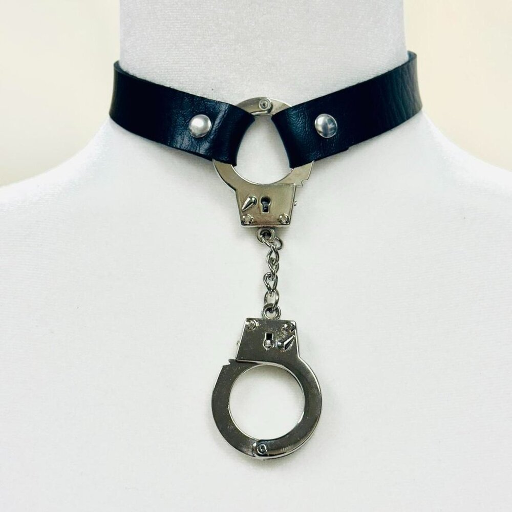 Black leather choker with silver metal handcuffs and chain